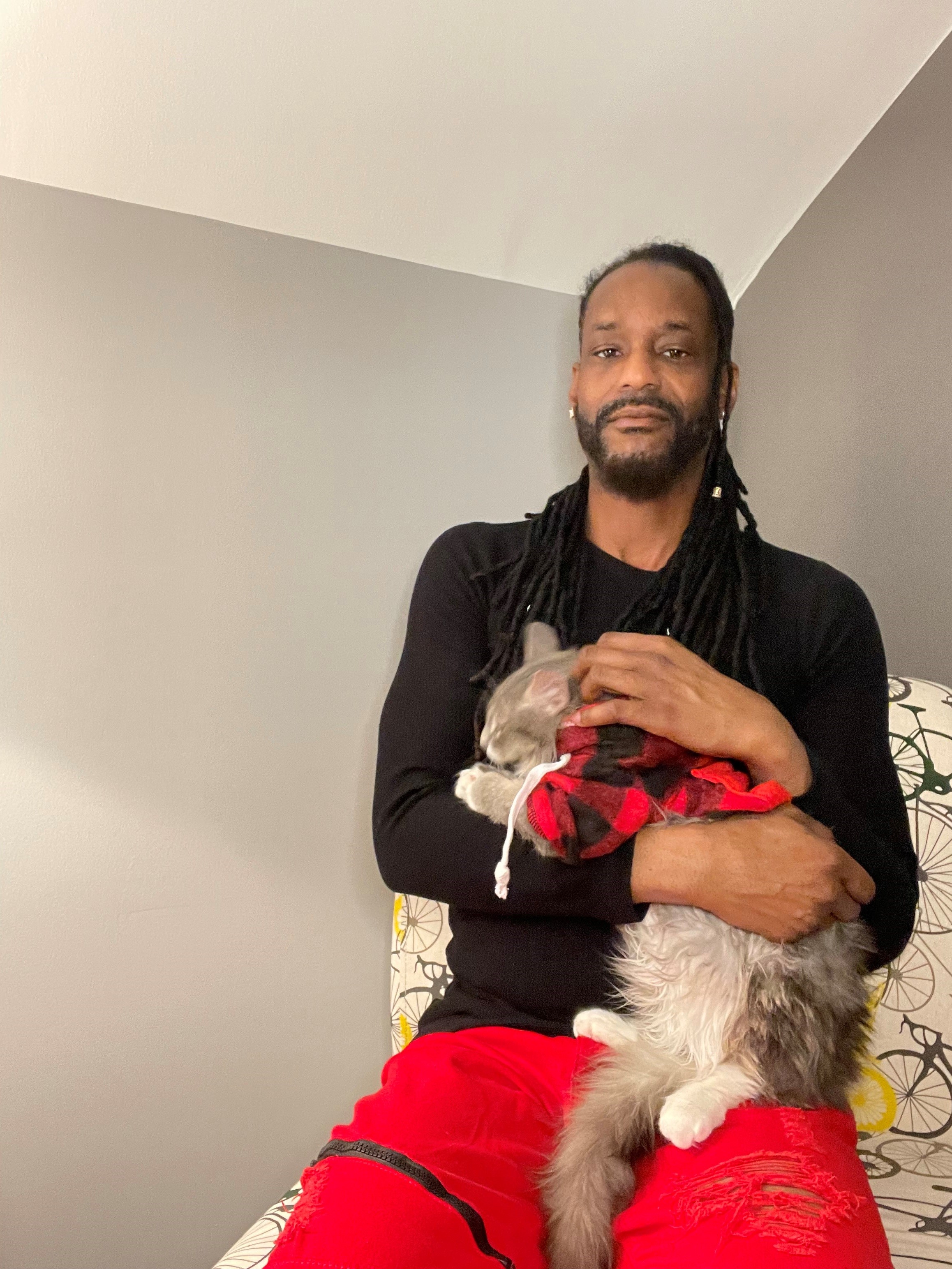 Dr. Nick seated and holding a cat