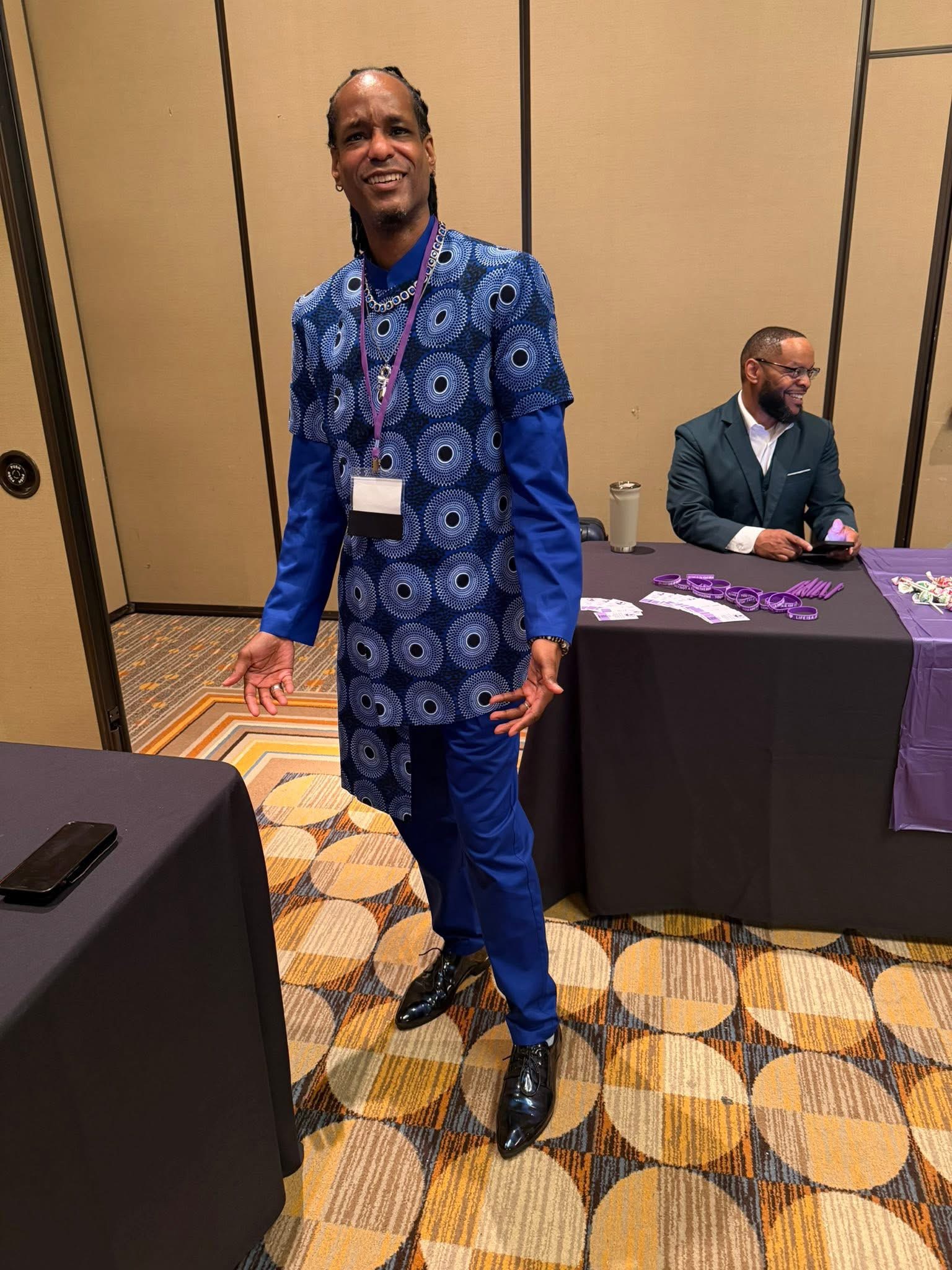 Dr. Nick at a professional conference in a blue outfit