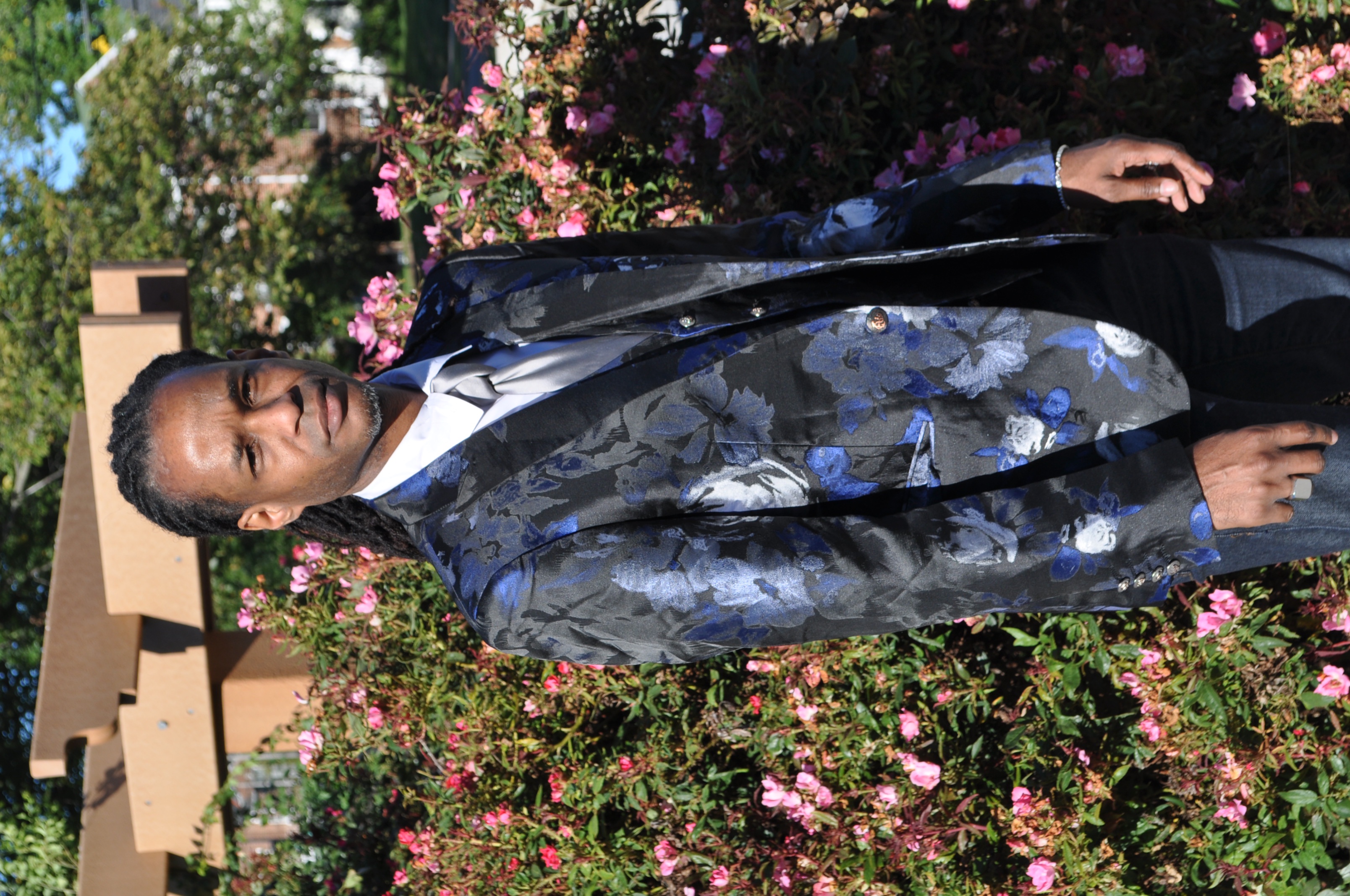 Dr. Nick standing outdoors in a formal floral jacket