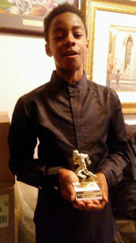 Ian holding an award during the time he lived with Dr. Nick